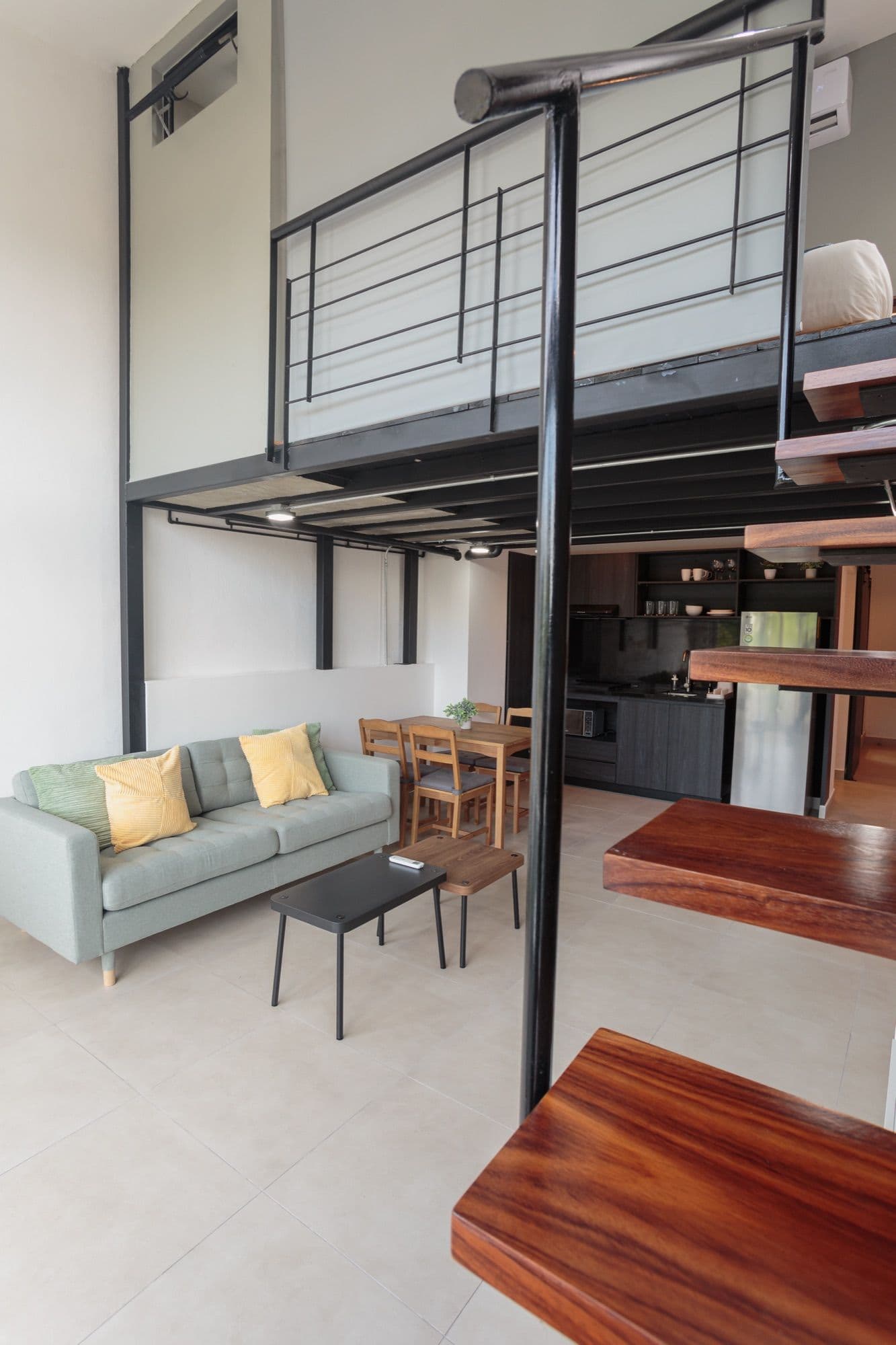 Sol living room with a lofted mezzanine and open kitchen.