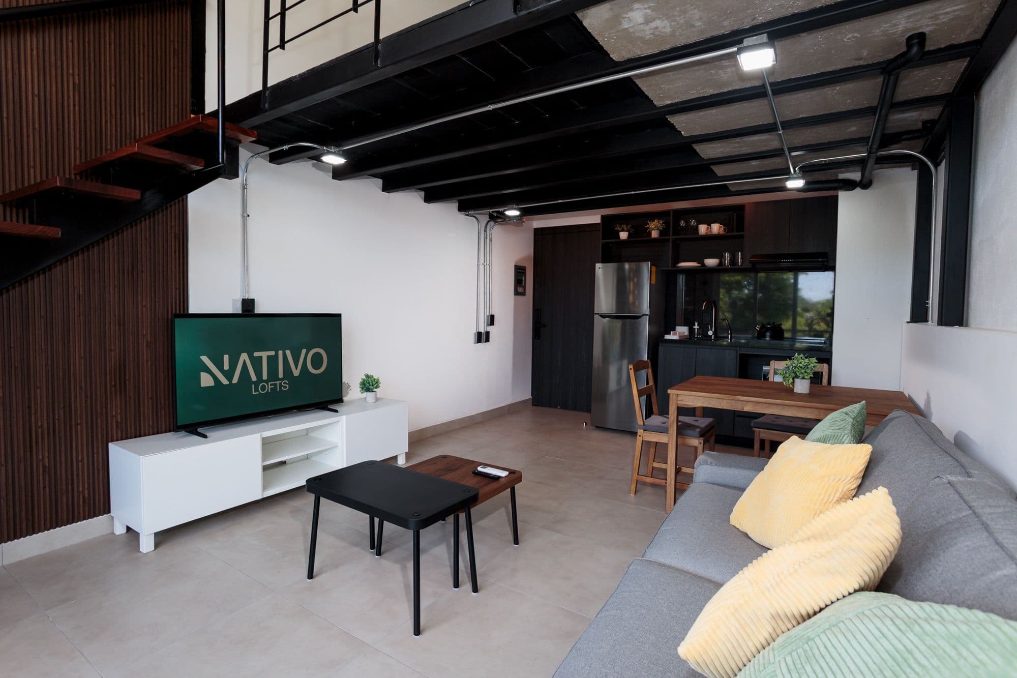 Mar living room with a lofted mezzanine and open kitchen.