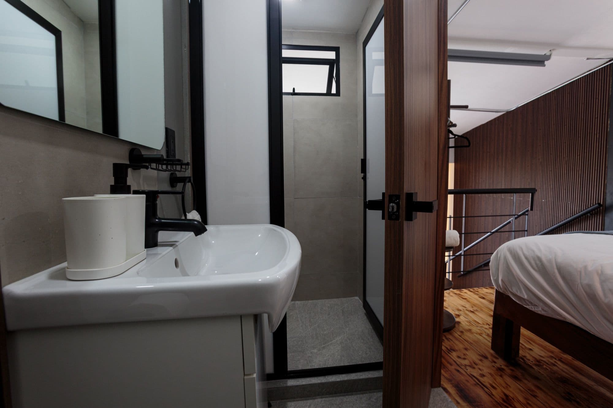 Mar bathroom opening onto the bedroom and stairs to the mezzanine.